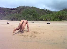 Naked breakdance on beach